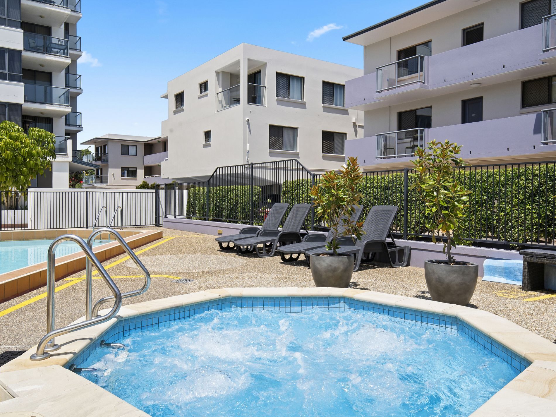 Aqualine building pool deck with palm trees